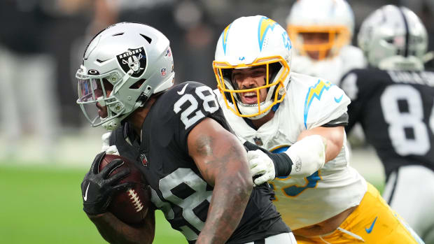 Dec 4, 2022; Paradise, Nevada, USA; Los Angeles Chargers cornerback Michael Davis (43) tackles Las Vegas Raiders running back Josh Jacobs (28) during the first half at Allegiant Stadium. Mandatory Credit: Stephen R. Sylvanie-USA TODAY Sports